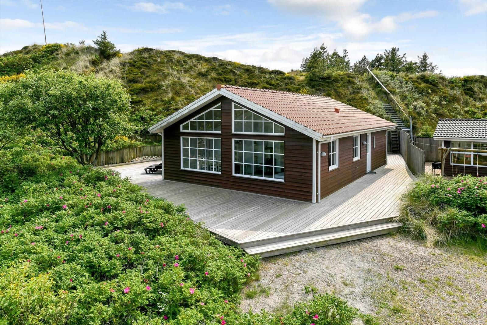 Wooden house with large attic and terrace in green surroundings