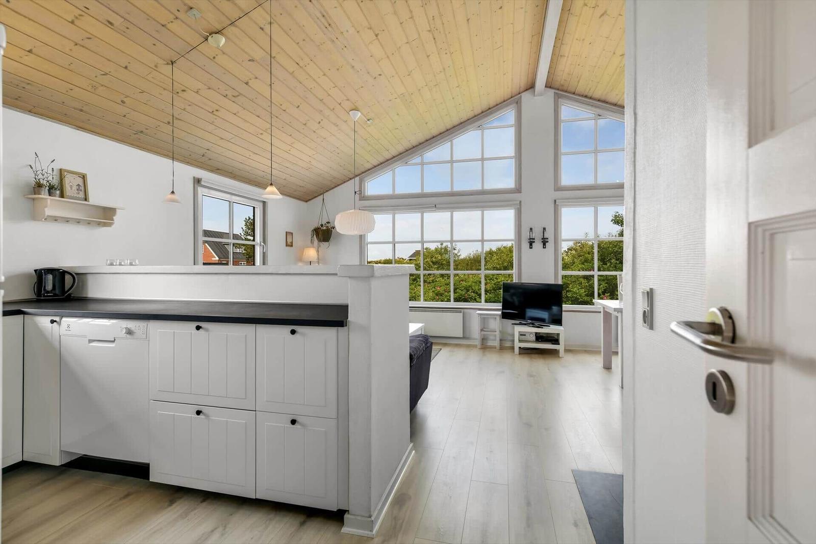 Kitchen with dining area and large window view of the landscape.