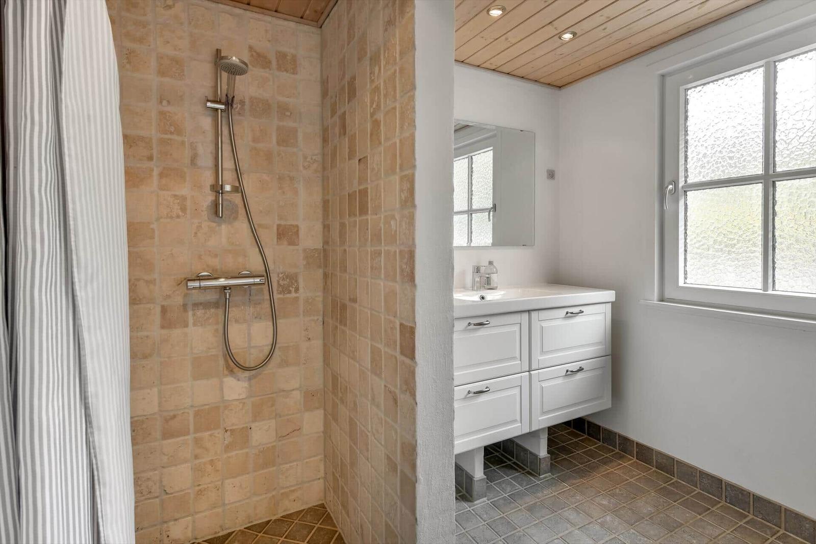 Shower with shower head and sink with mirror