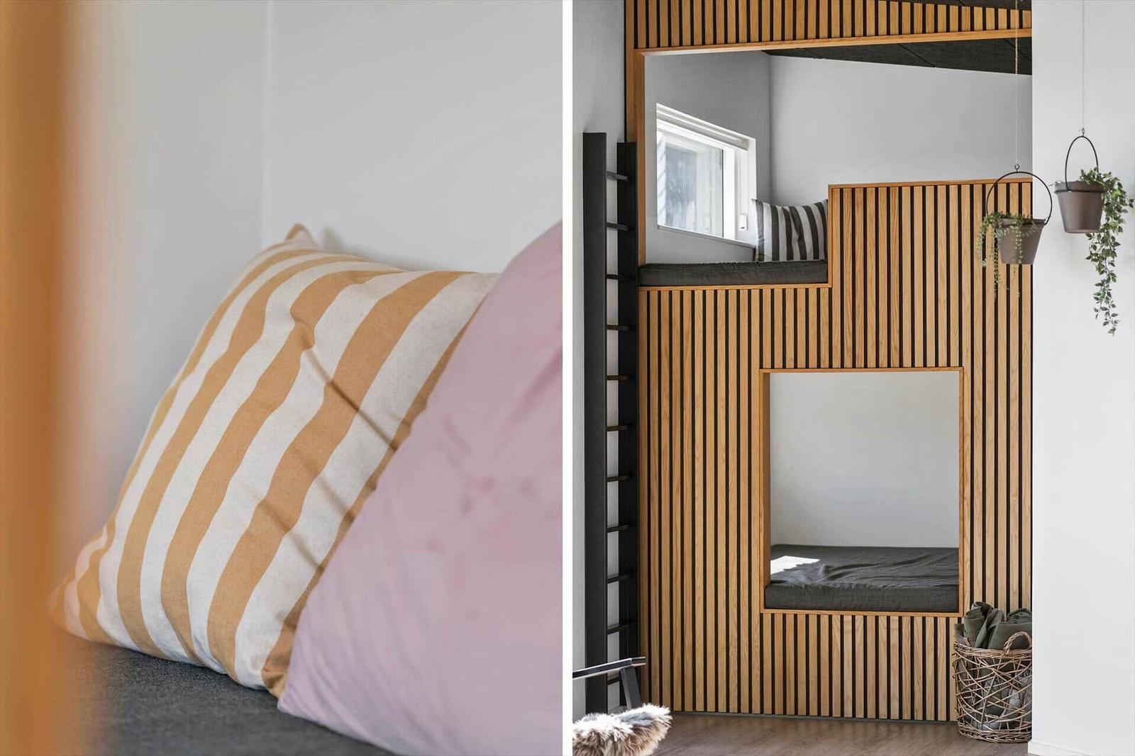 Schlafzimmer mit Holzpaneelen, Kissen und Aufbewahrungskorb.