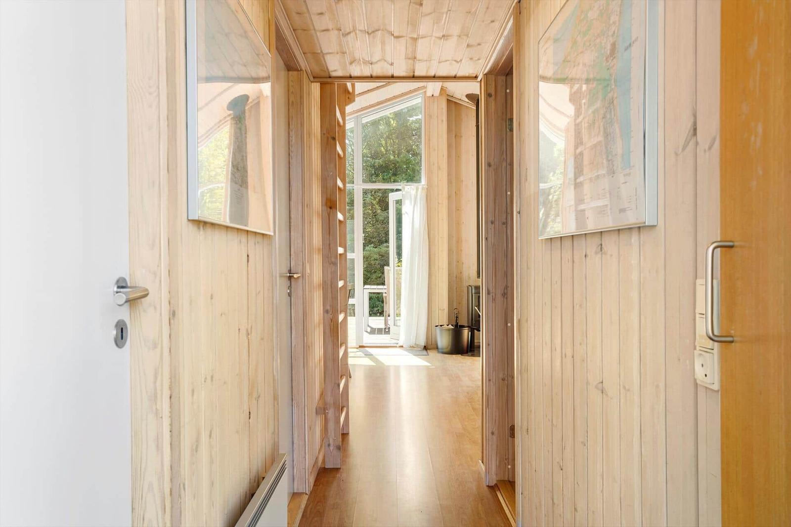 Wood-paneled hallways with maps and view to terrace