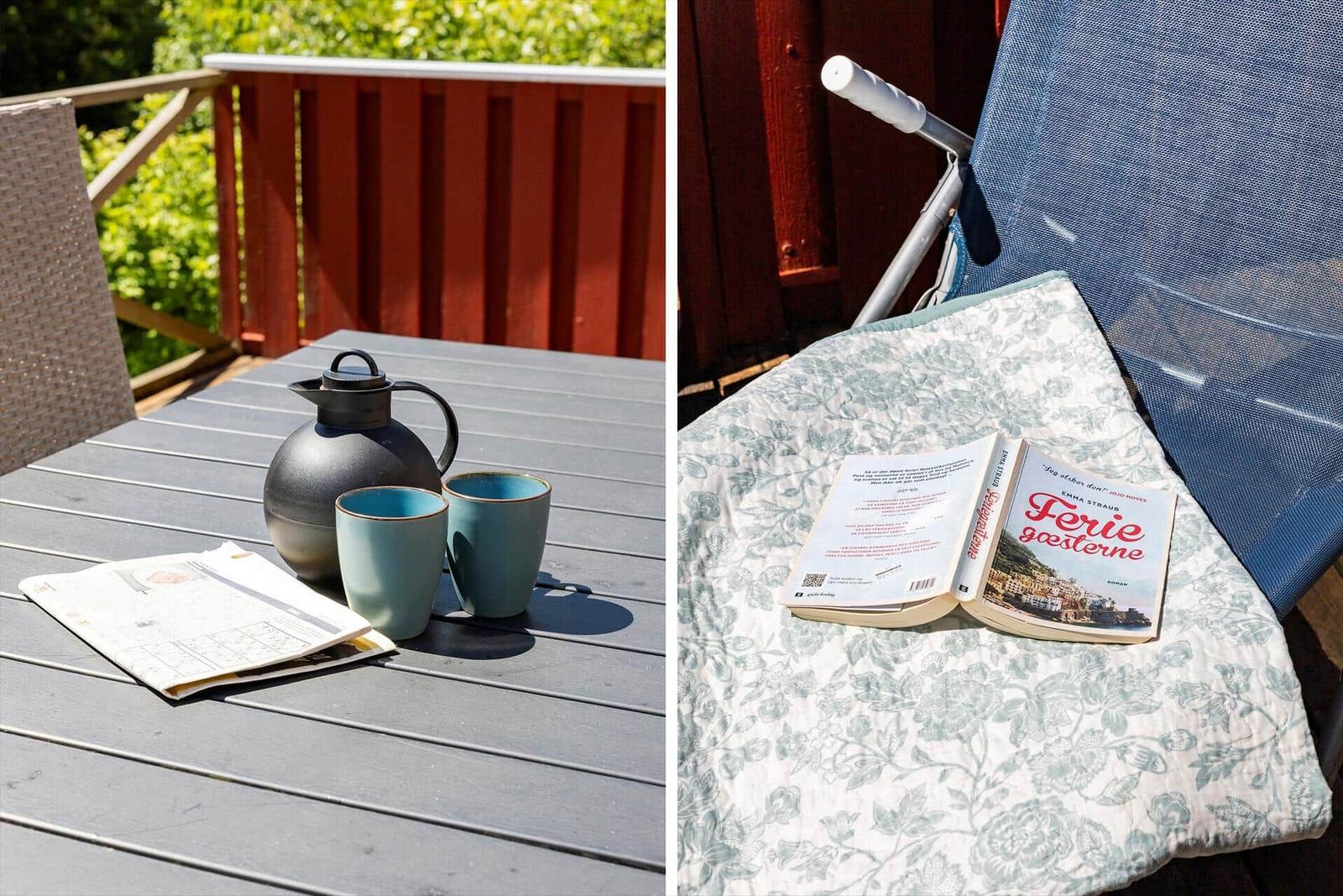 Deck with table, thermos, and mugs. Lounge chair with cushion and open book.