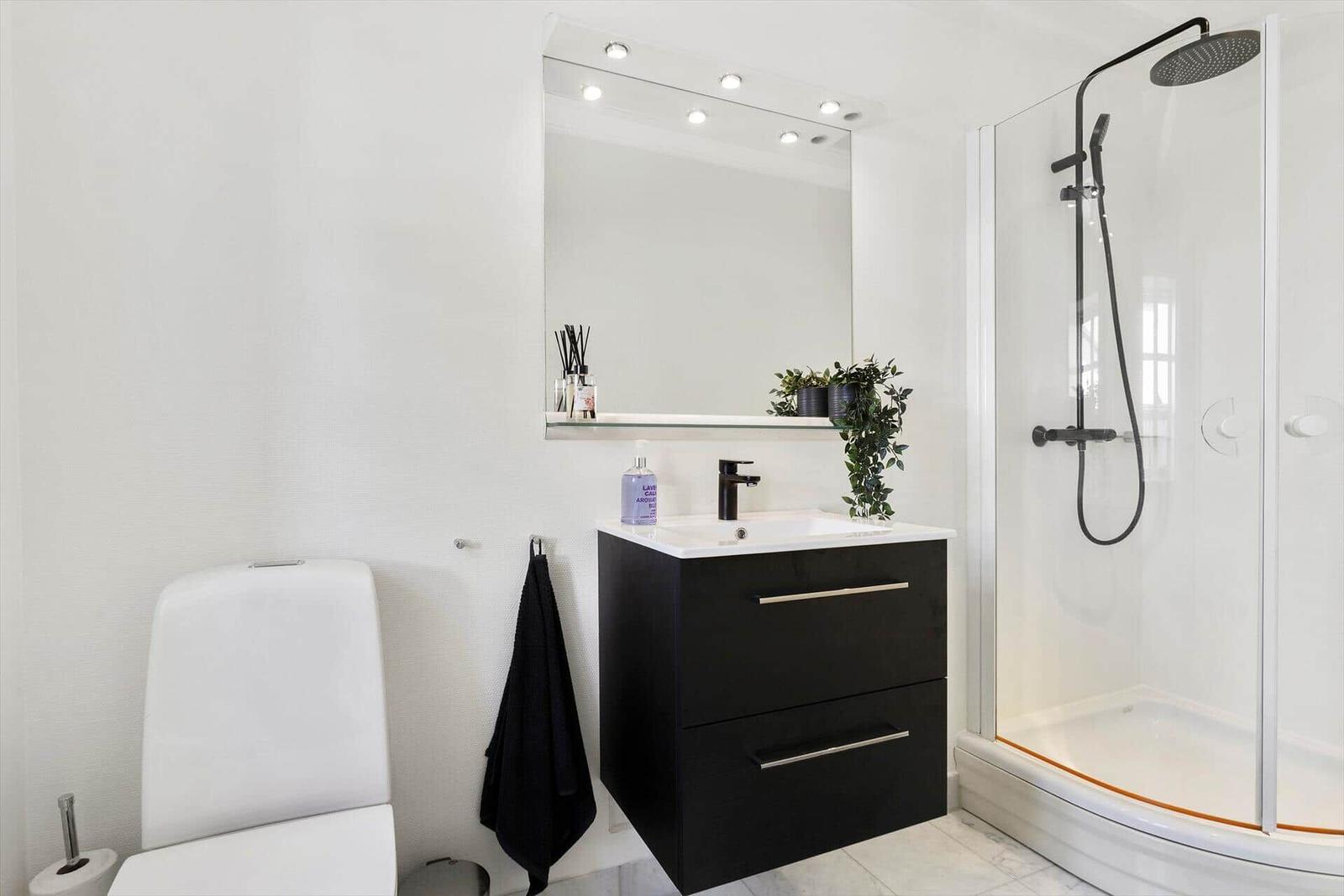 Bathroom with shower, sink and toilet.
