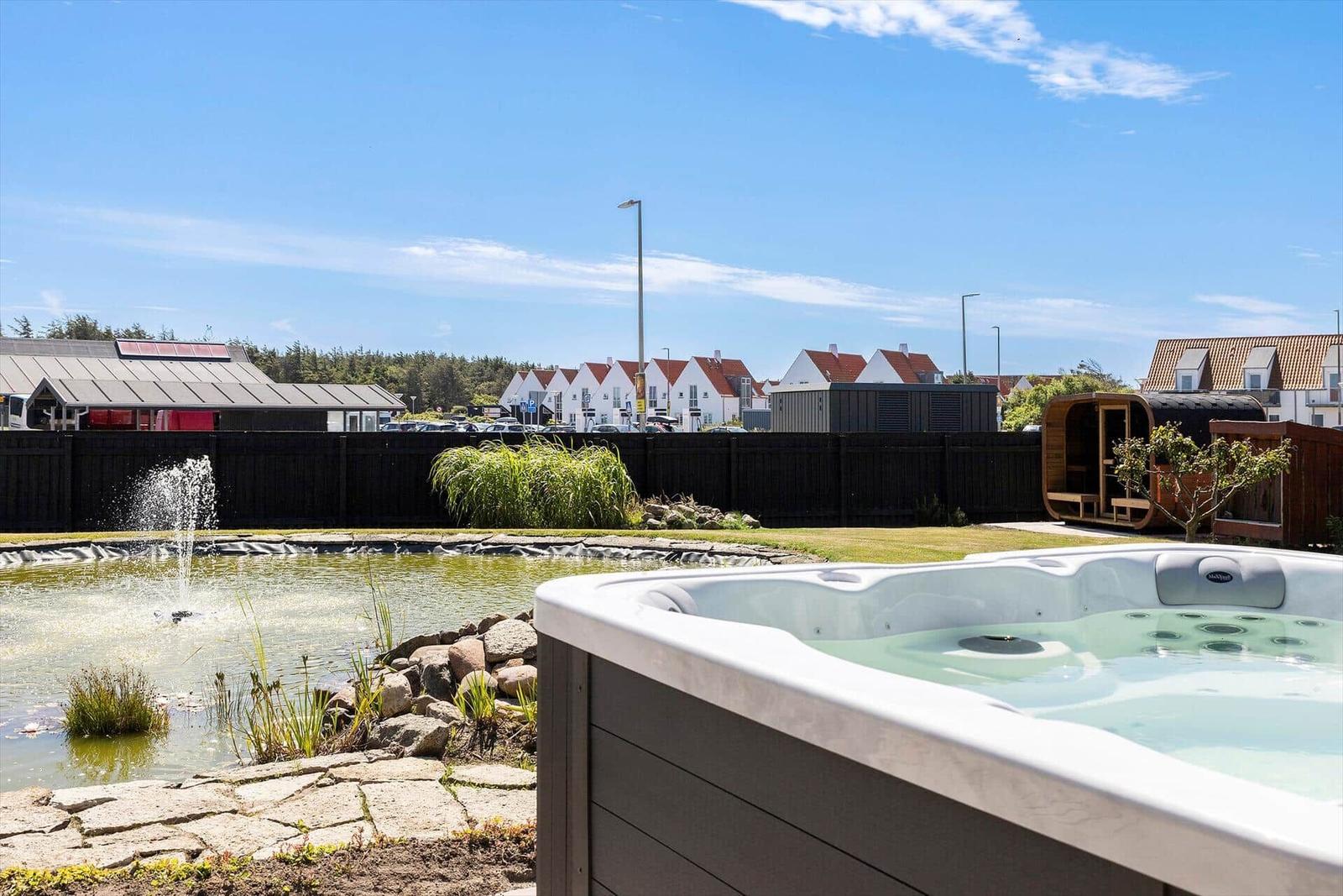 Hot tub with view of a pond and garden.