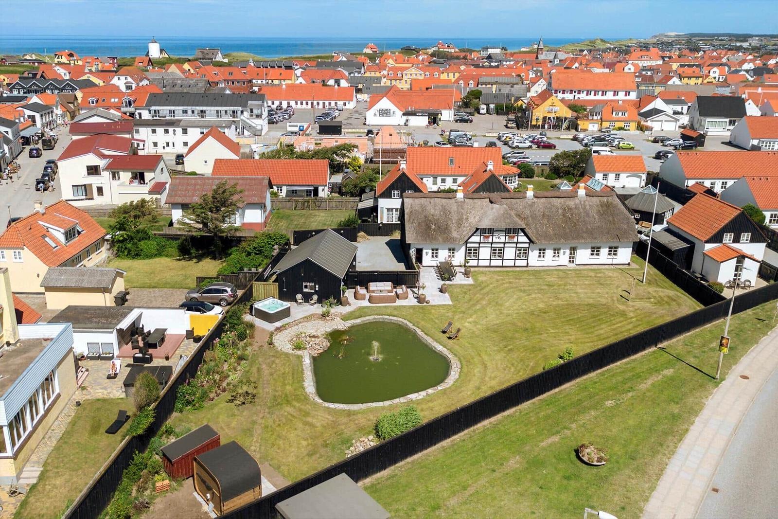 House with garden, pond, and pool. View of town and sea.