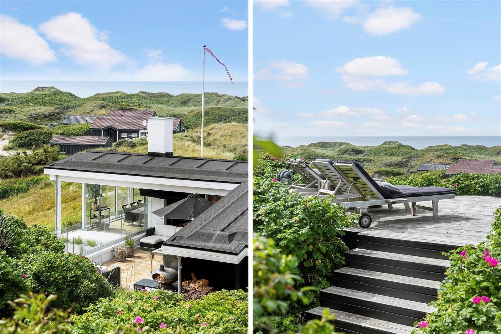 Modern house with terrace and sea view. Outdoor terrace with sun loungers and view of dunes.