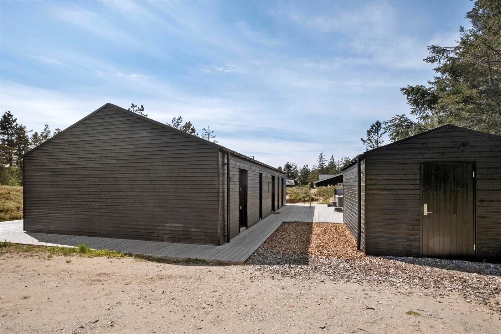 Moderne Holzhäuser mit Terrasse und Wald umgeben