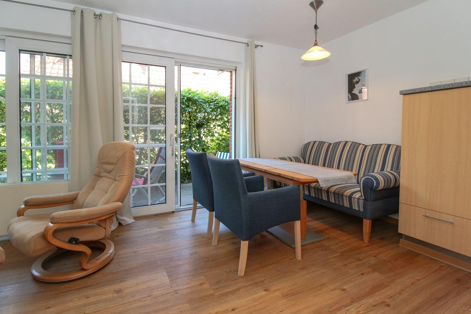 Wohn- und Essbereich mit Sitzgelegenheiten und Blick auf Garten