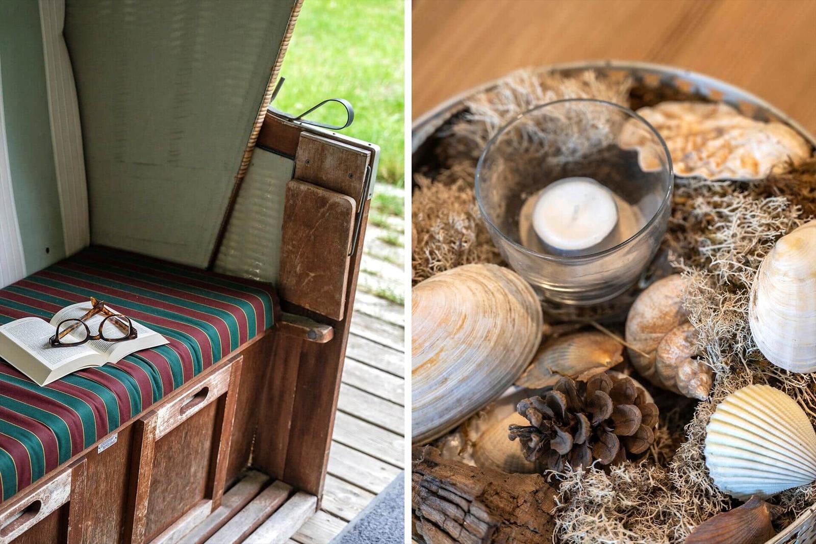 Sitzbank mit Buch und Brille. Dekoration mit Muscheln, Kiefernzapfen und Kerze.