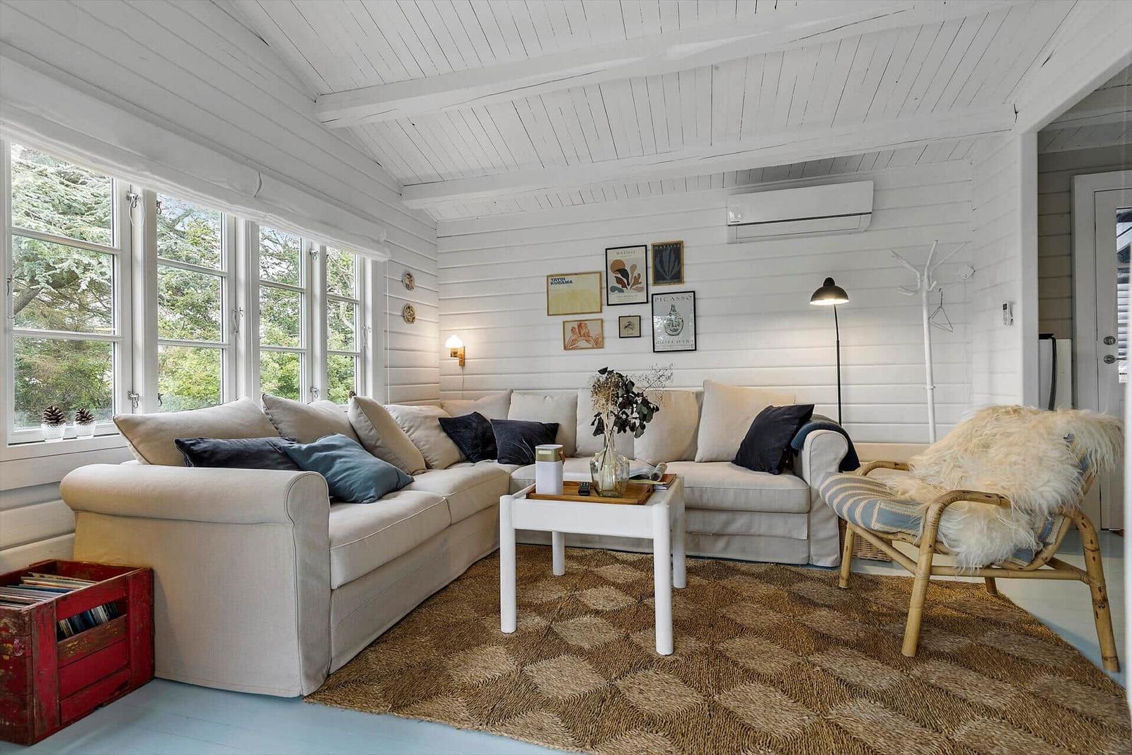 Living room with sofa, chair and view of greenery