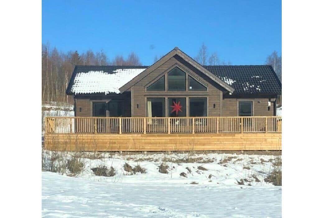 Holzhütte mit Terrasse und Schnee im Winter