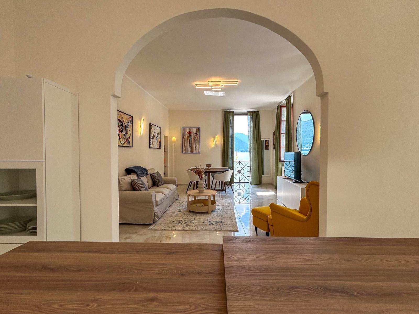 Living room with water view and balcony. Yellow armchair and sofa.