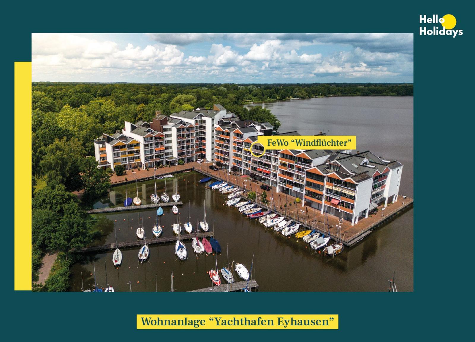 Wohnanlage Yachthafen Eyhausen mit Bootsanlegern und Wohnungen an Wasser.