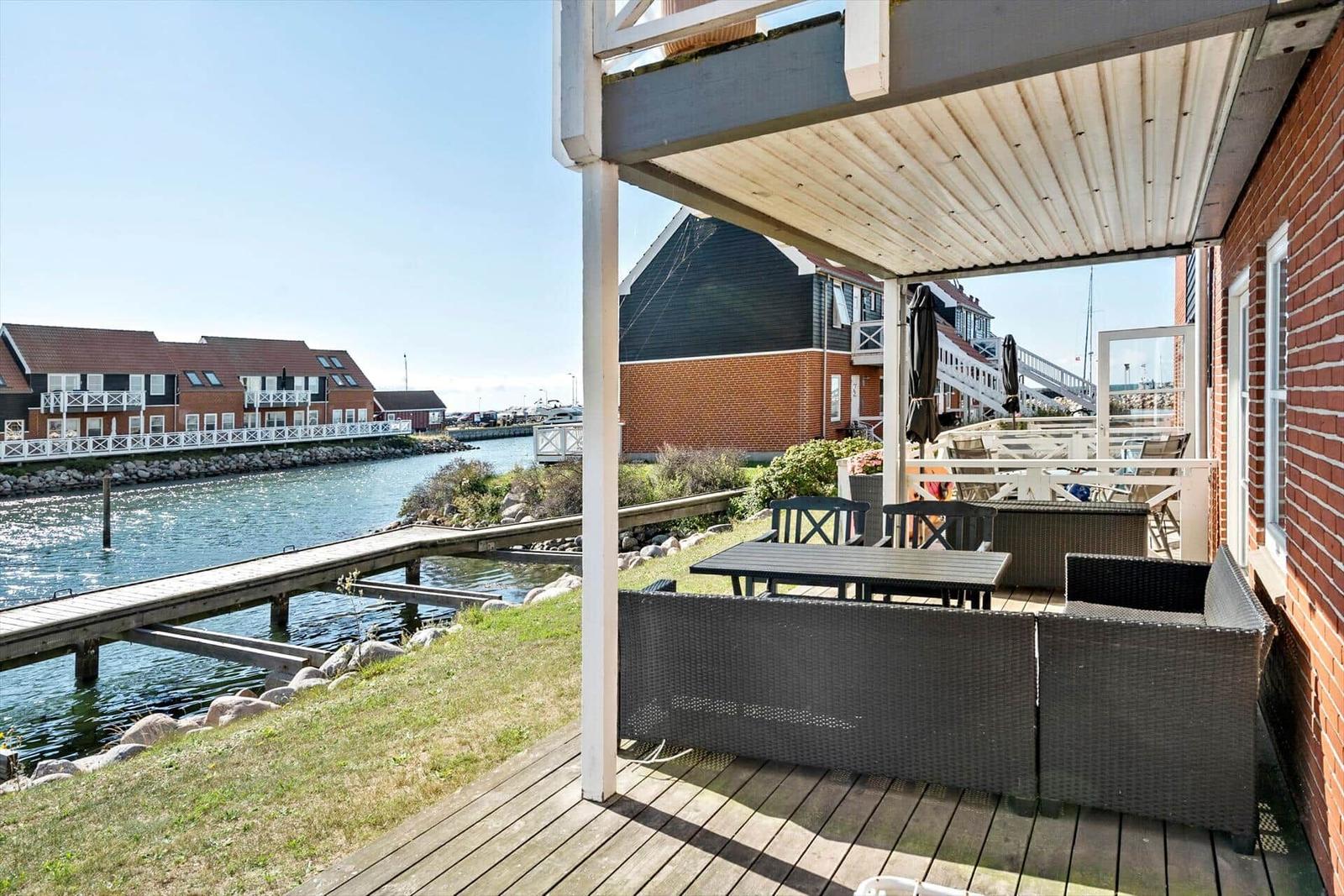 Terrasse mit Sitzgelegenheiten und Blick auf den Hafen.