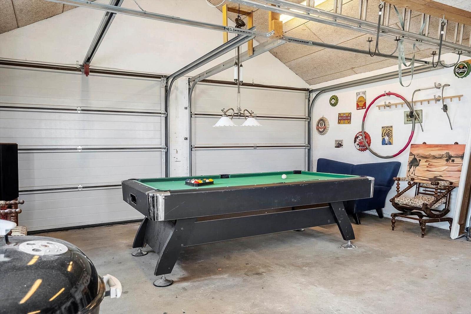 Garage with pool table, sofa, and chair