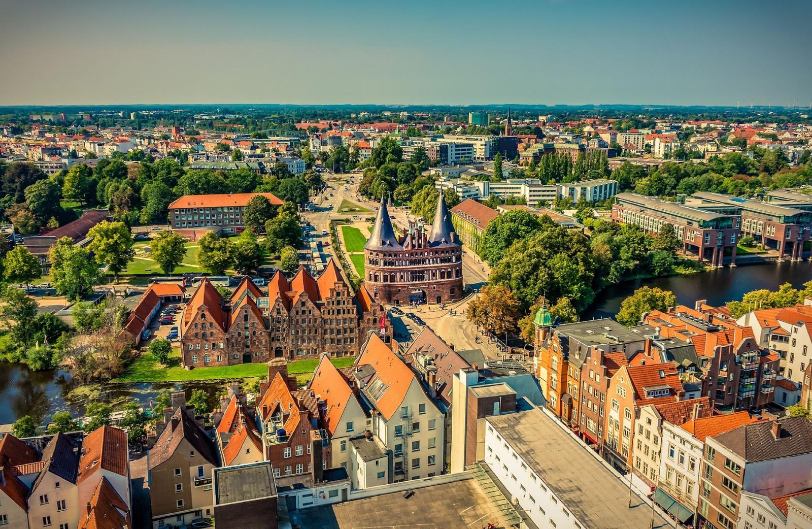 Aerial view of Lübeck with historic buildings and river.