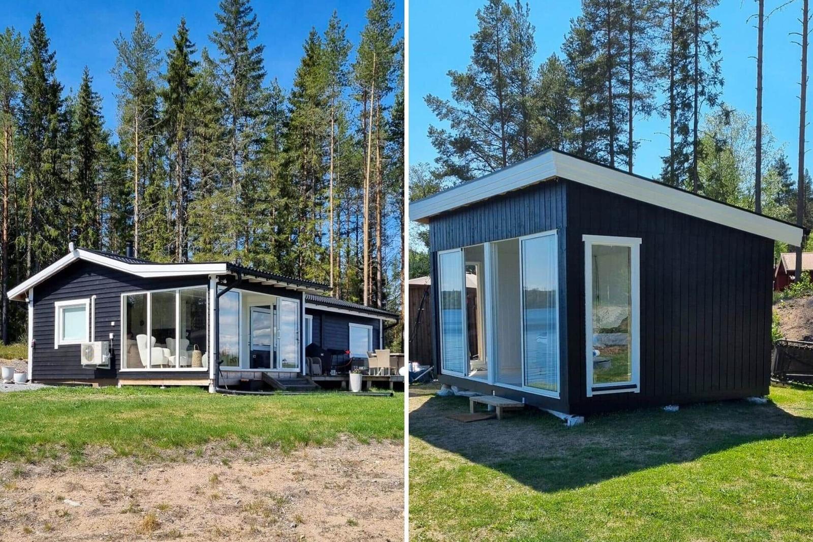 Zwei schwarze Häuser mit weißen Fenstern und Terrassen im Wald.