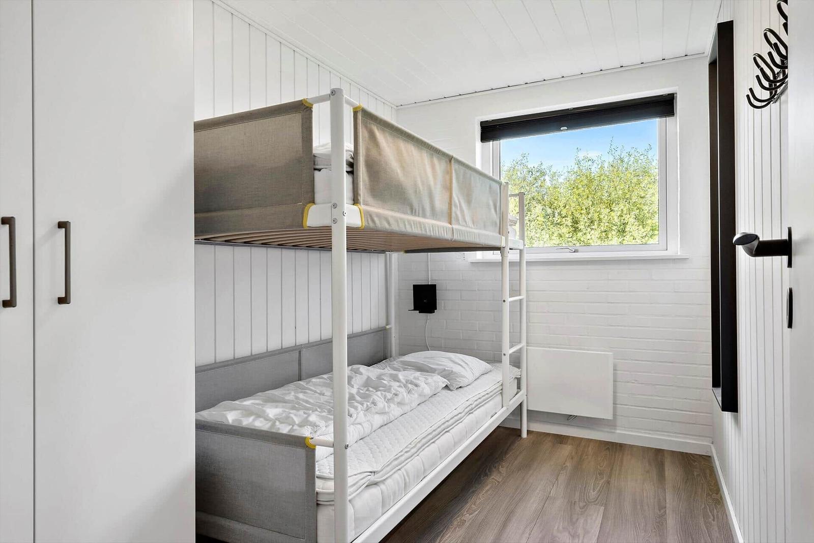 Bedroom with bunk bed and window to the garden