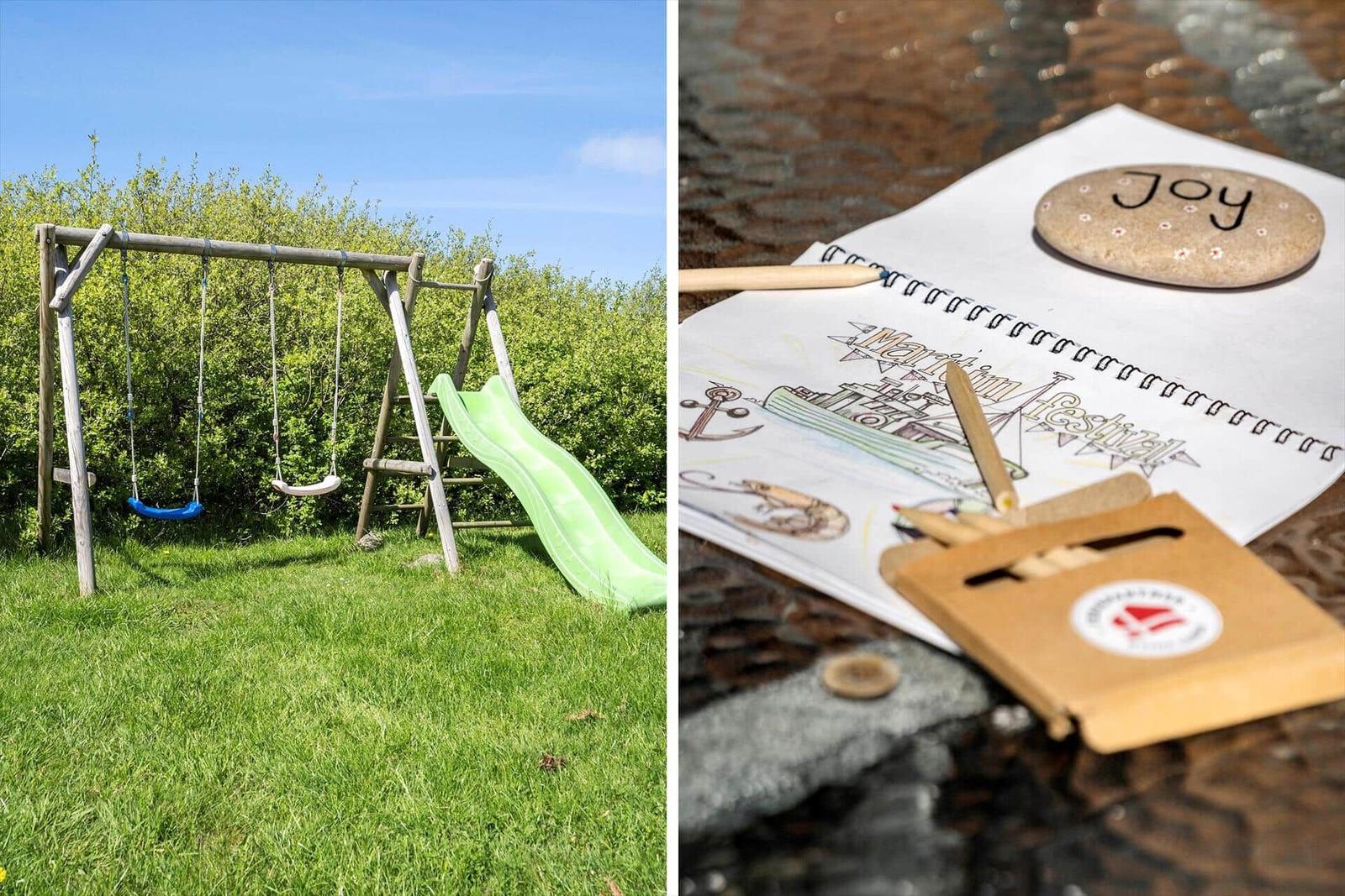 Backyard with swing and slide. Table with coloring set and stone with Joy.