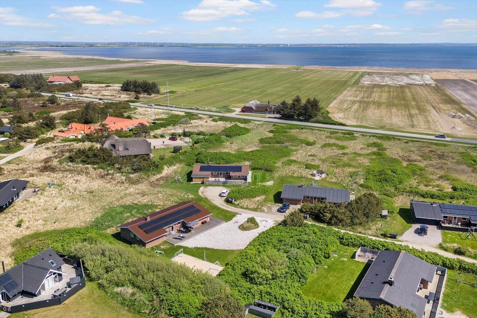 Aerial view of vacation homes near a large body of water.