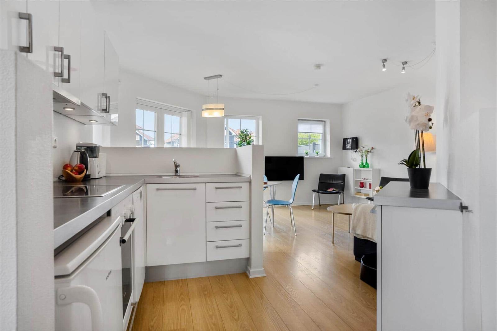 Kitchen with countertop and dining area with chairs.