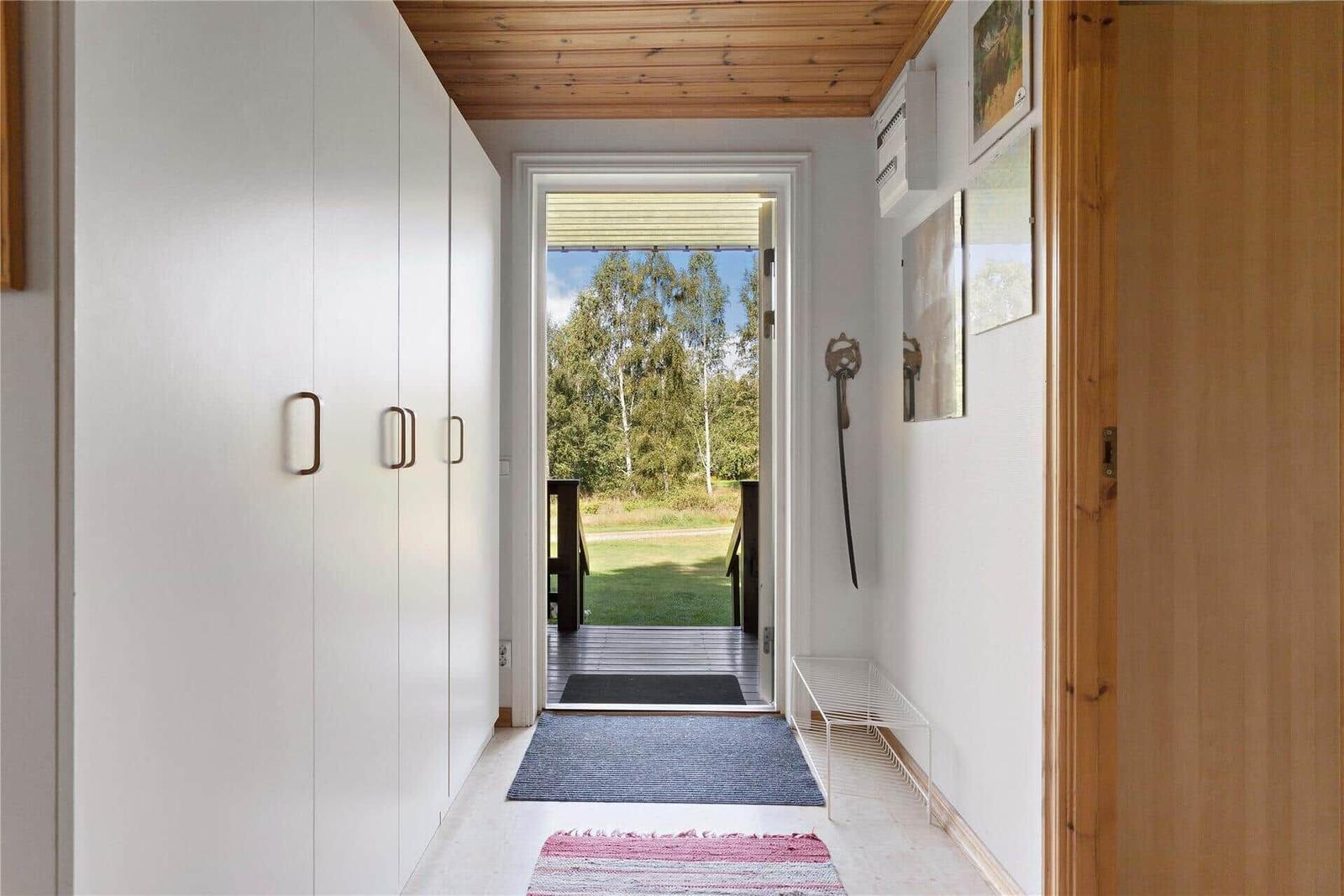 Entrance with wardrobe, pictures, and view to the terrace.