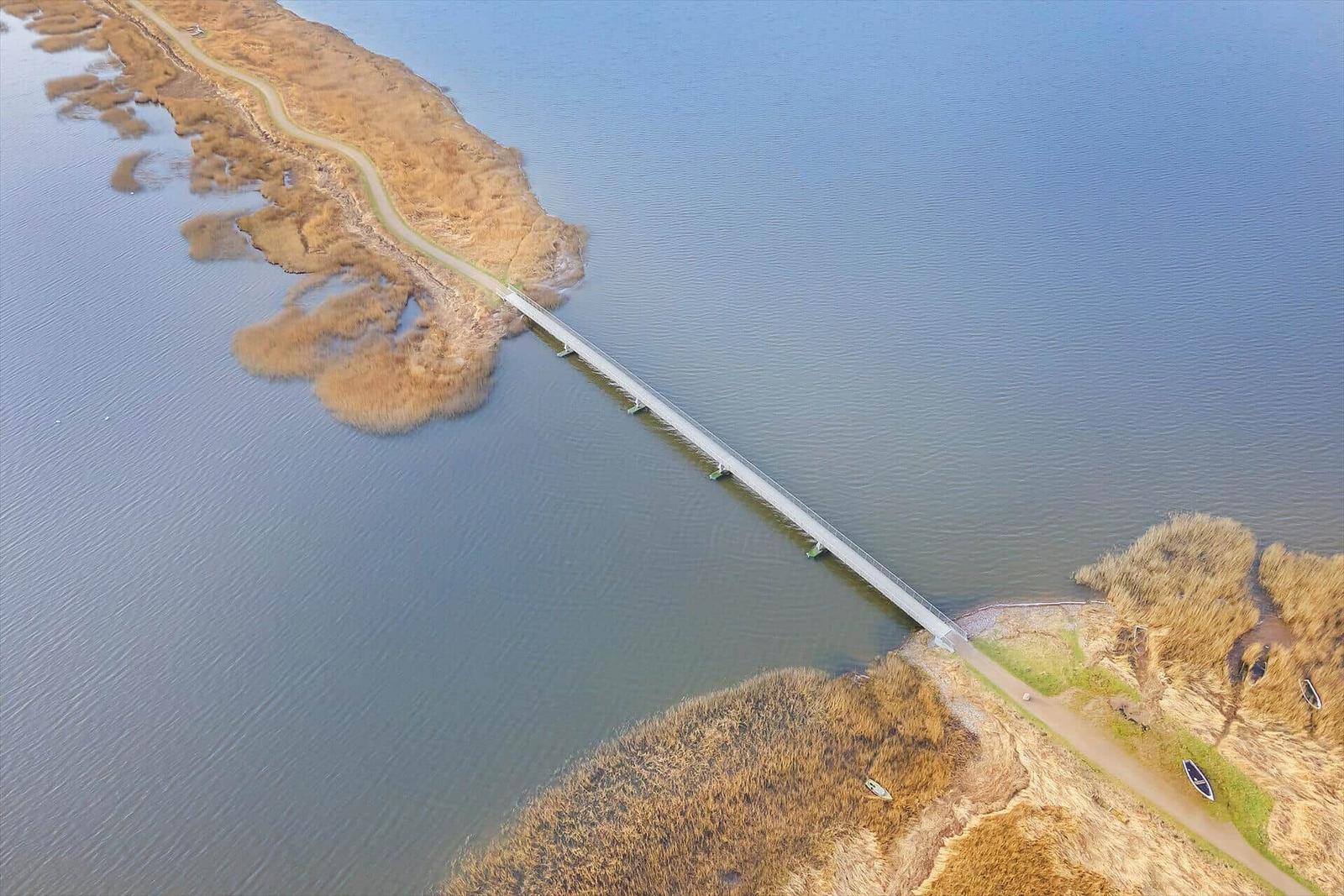 Bridge over a lake with paths and boats