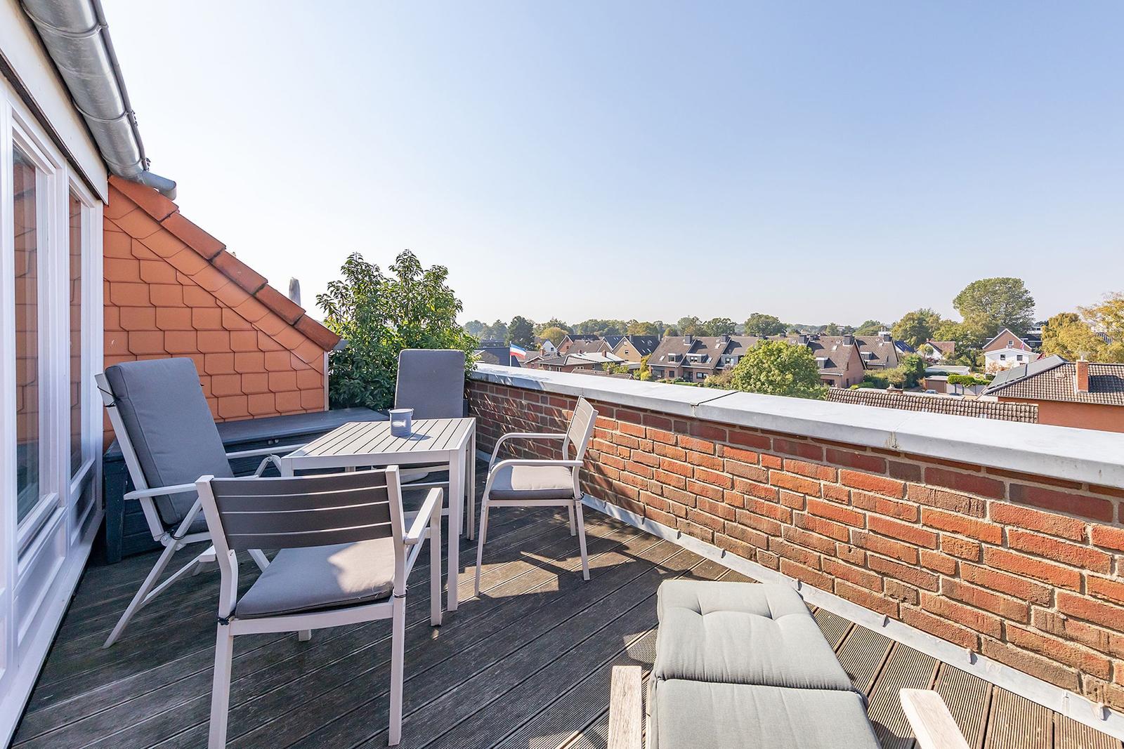 Terrasse mit Sitzgelegenheiten und Blick auf die Stadt