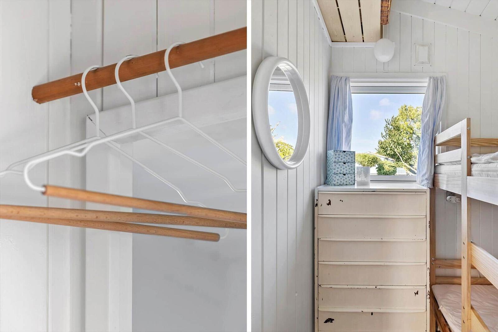 Closet with wooden rods and white hangers. Bedroom with dresser, mirror, and bunk bed.