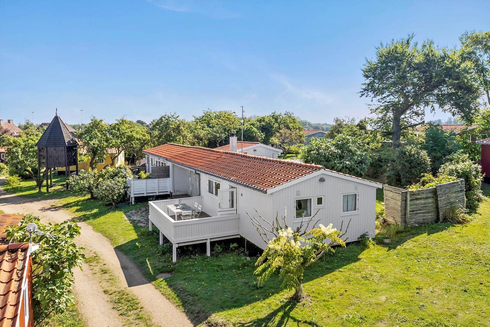 House with terrace and garden in green surroundings.