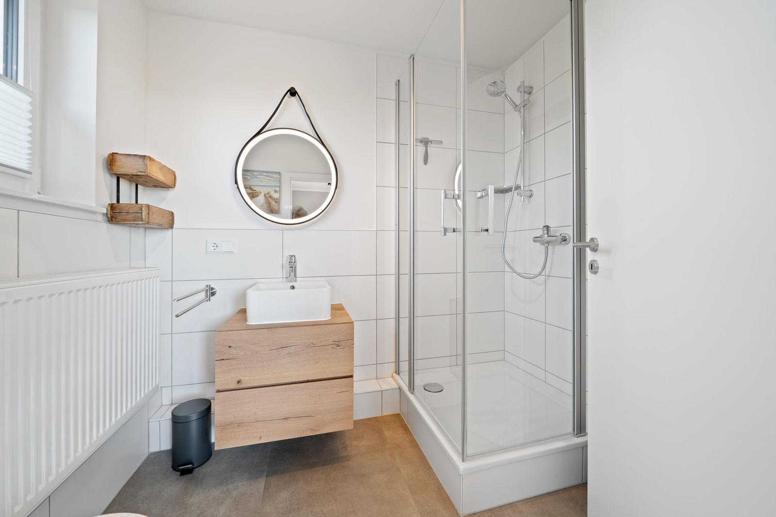 Bathroom with shower, sink, and mirror