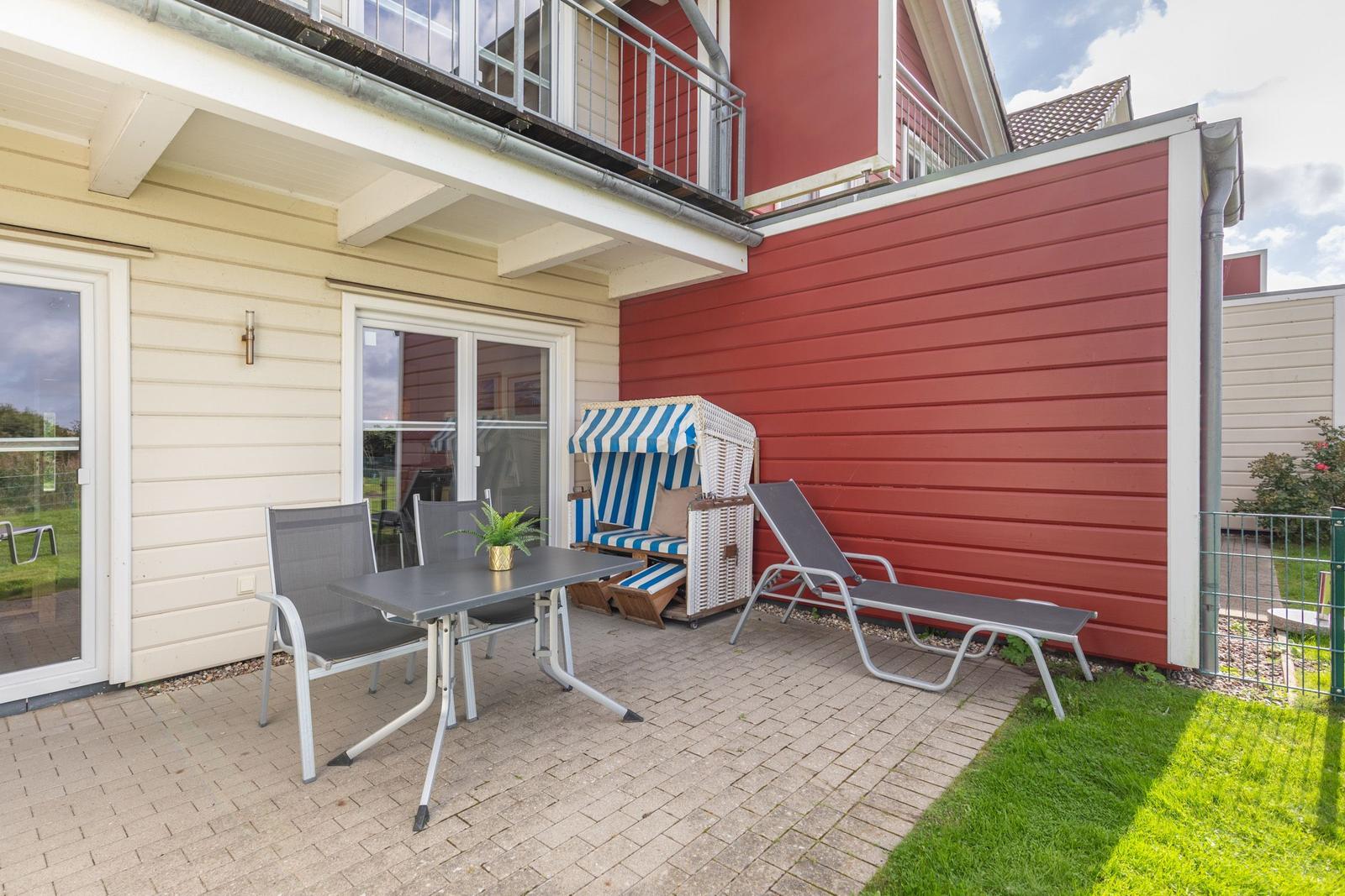Terrace with table, chairs, sun lounger, and beach chair.