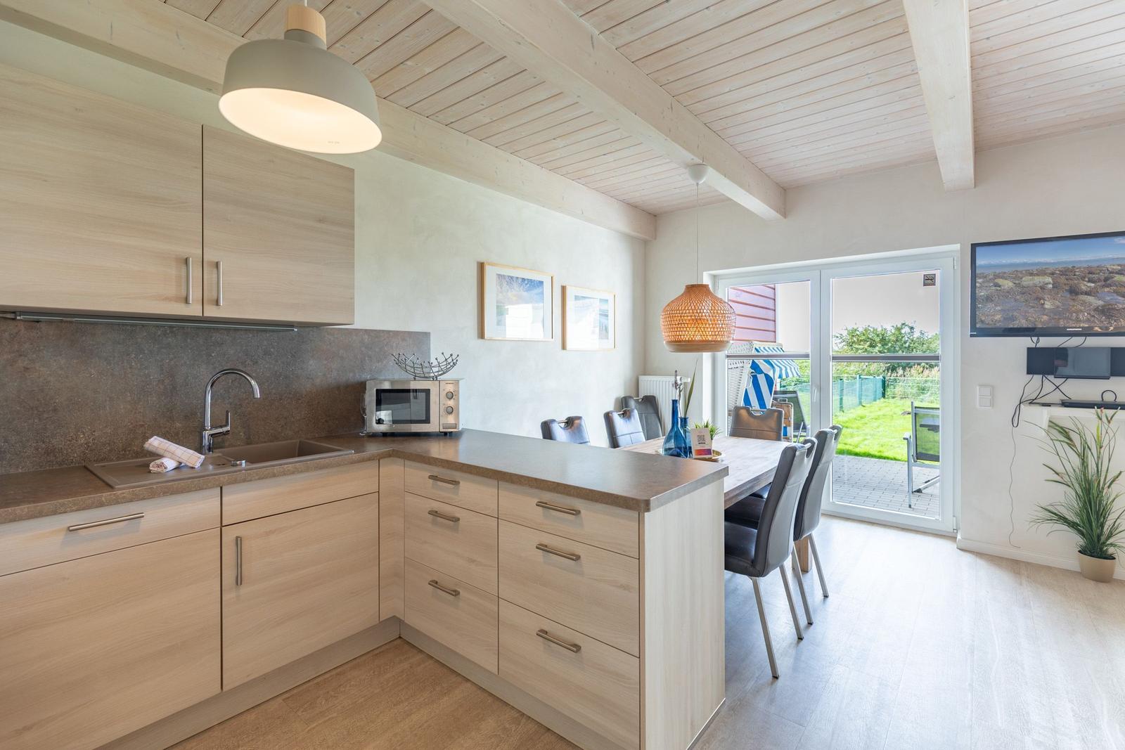 Kitchen with dining area and view of balcony