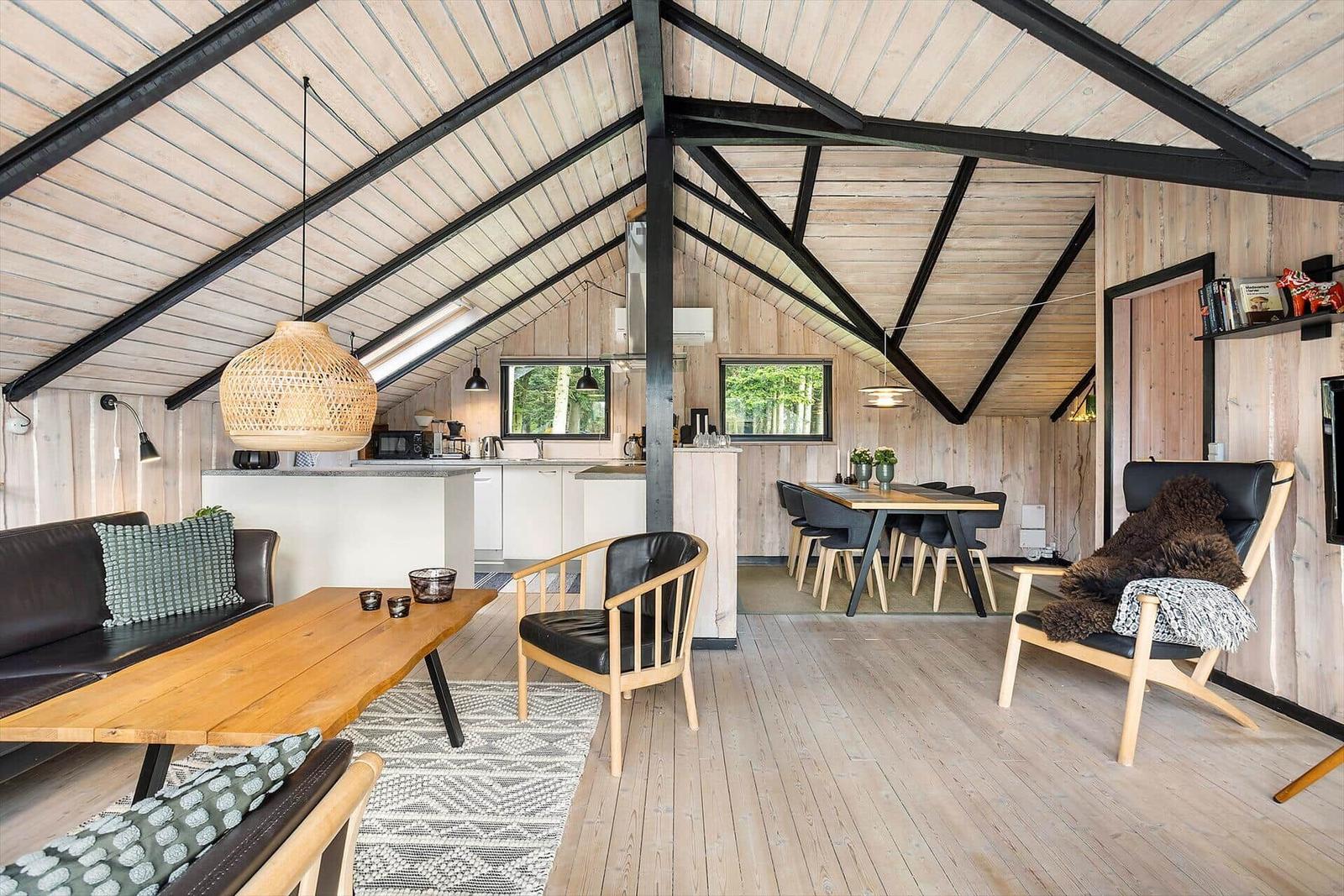 Living area with dining and kitchen under wooden roof