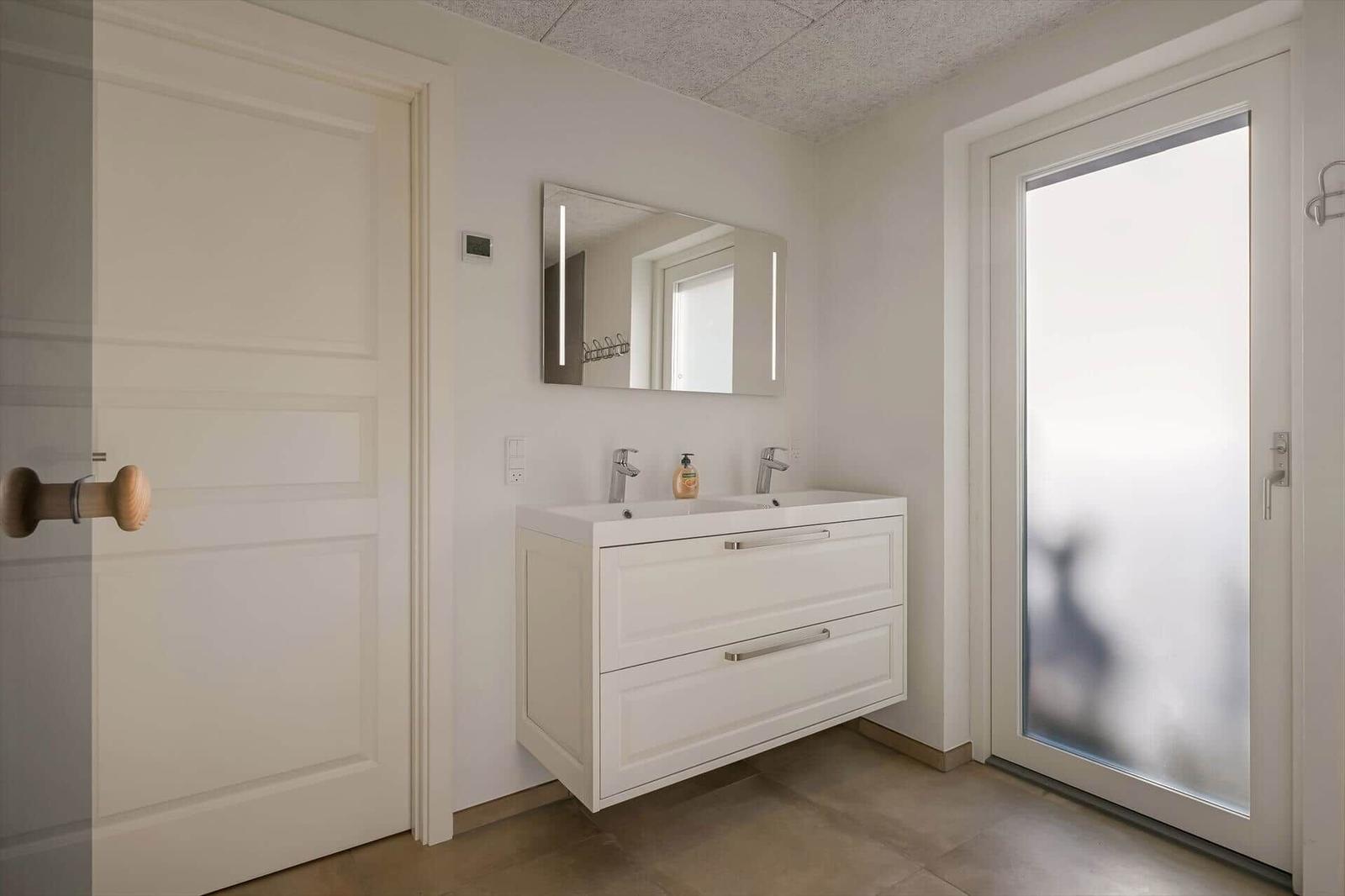 Bathroom with sink, mirror and door