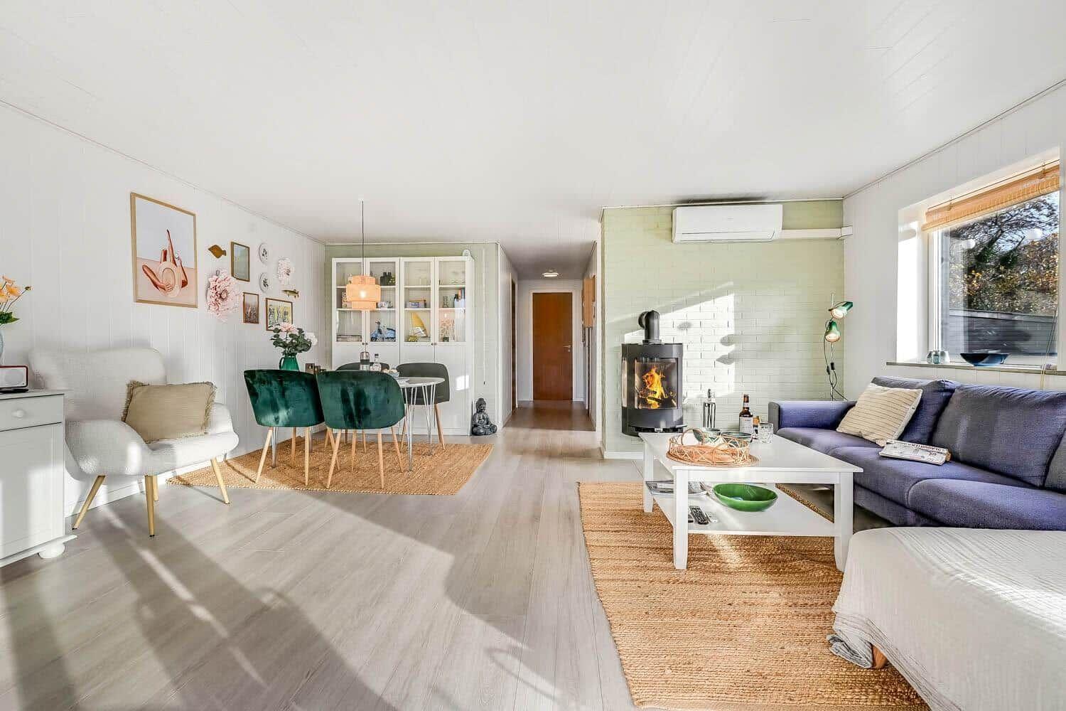 Living and dining area with fireplace, sofa, and dining table