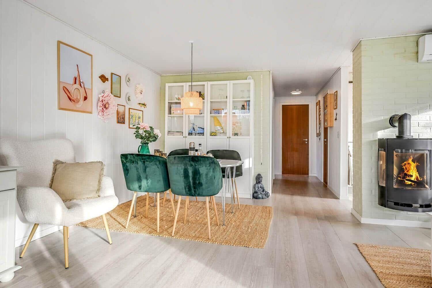 Living and dining area with fireplace, dining table, and seating.