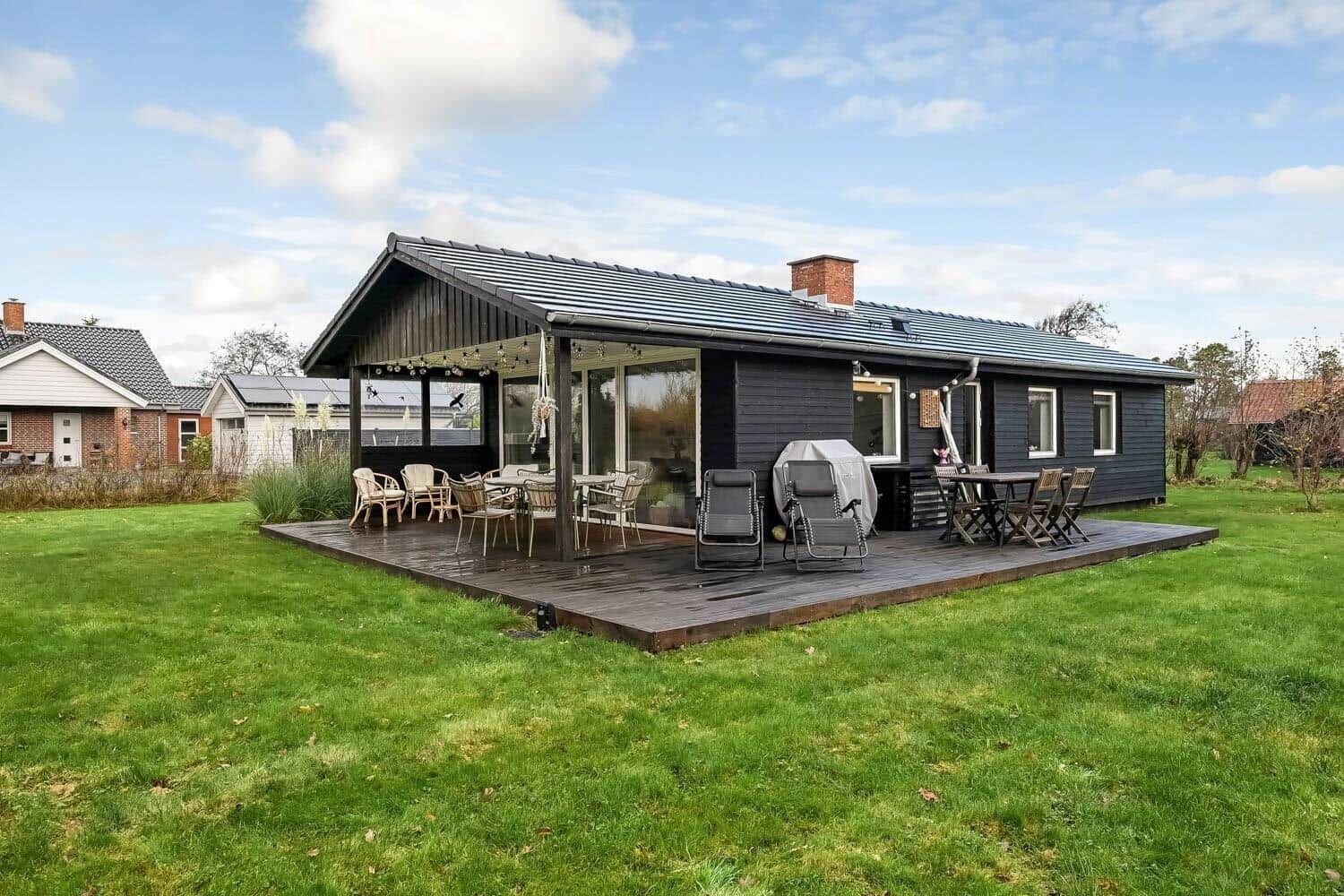 A house with terrace, garden and outdoor seating areas.