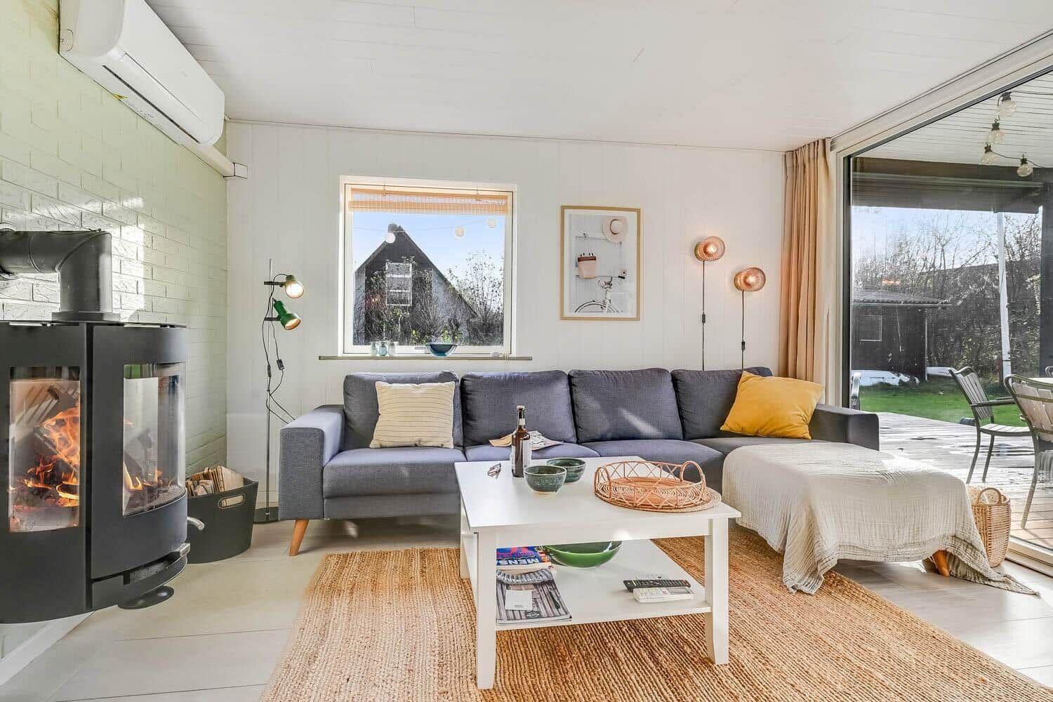 Living room with sofa, fireplace, and terrace