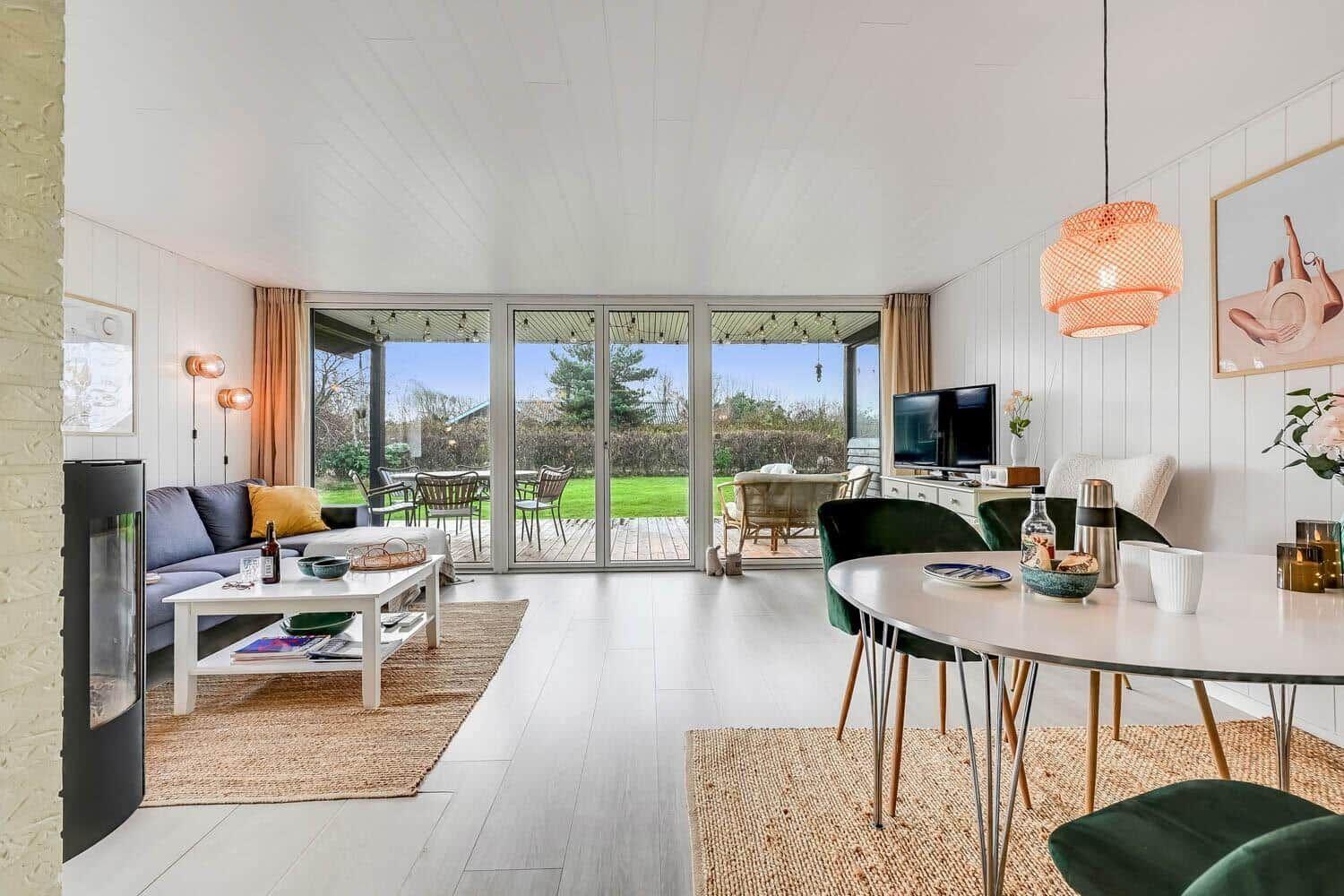 Living and dining area with view of garden and terrace.
