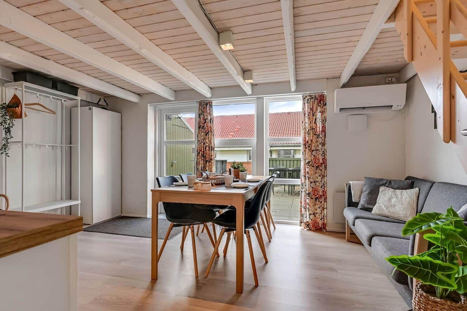 Living area with dining table, sofa, and view of terrace