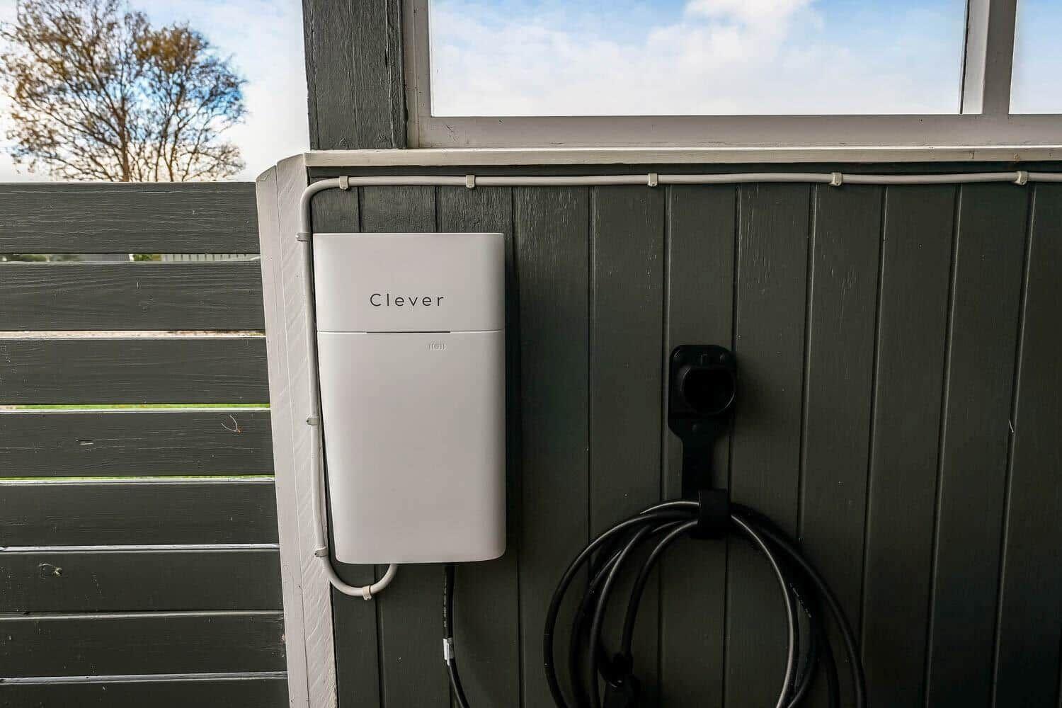 Charging station mounted on wall with coiled cable