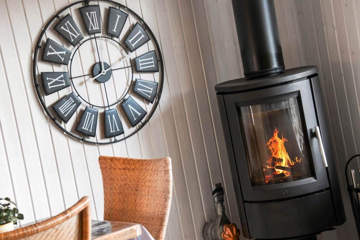 Living room with fireplace and wall clock with Roman numerals.