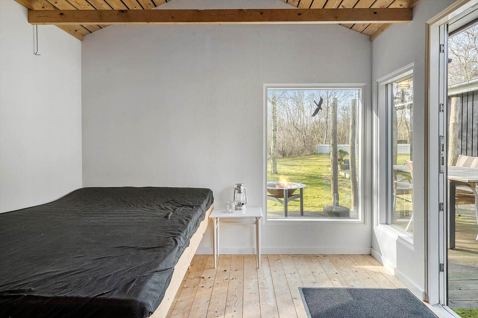 Bedroom with bed, window, and terrace