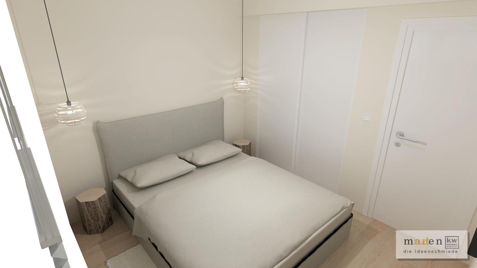 Schlafzimmer mit Bett, Kleiderschrank und zwei Hängelampen.