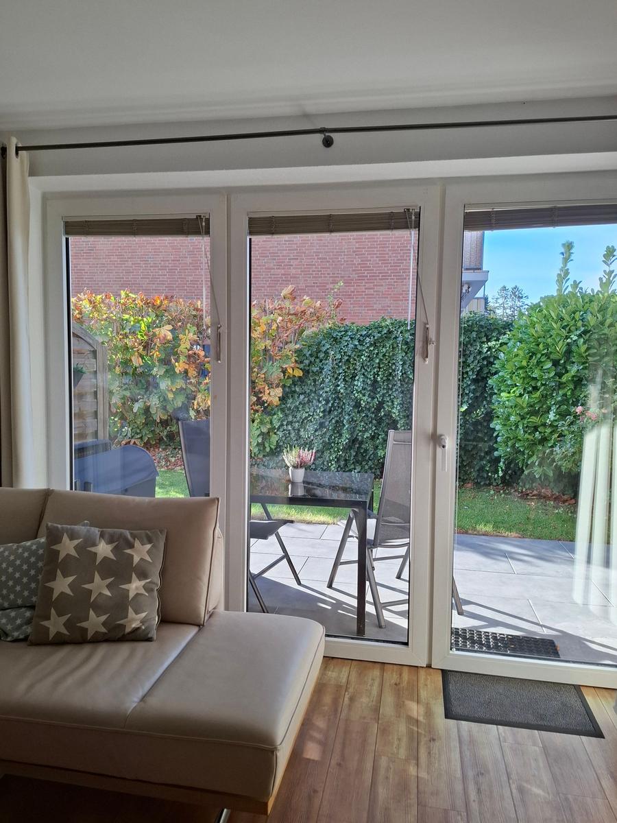 Wohnzimmer mit Blick auf die Terrasse und den Garten.