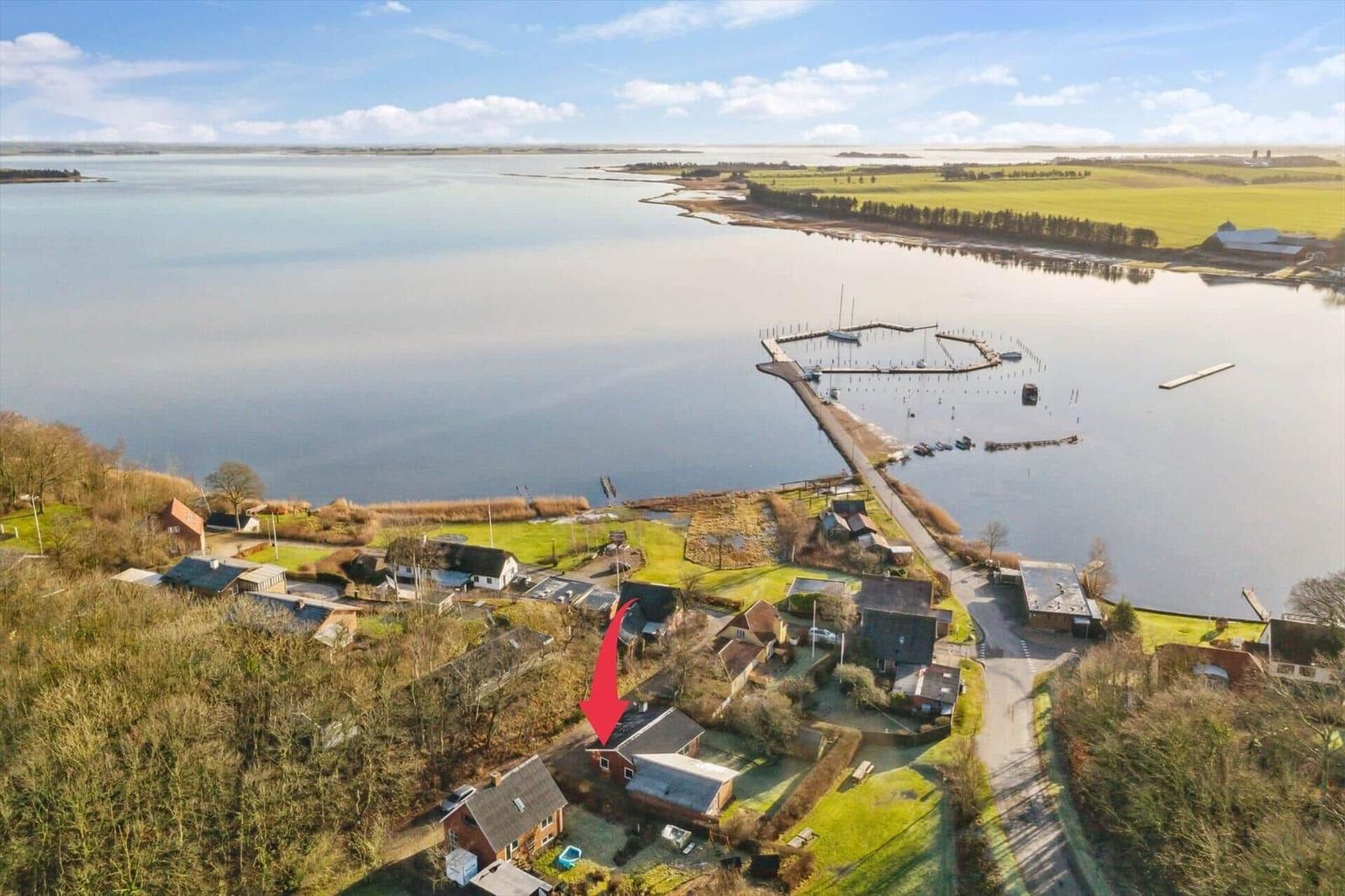 House by water with view of harbor and fields