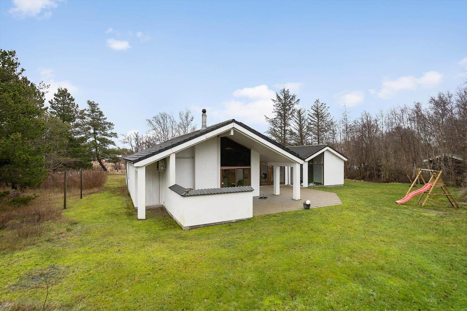 House with large garden and playground outdoors.