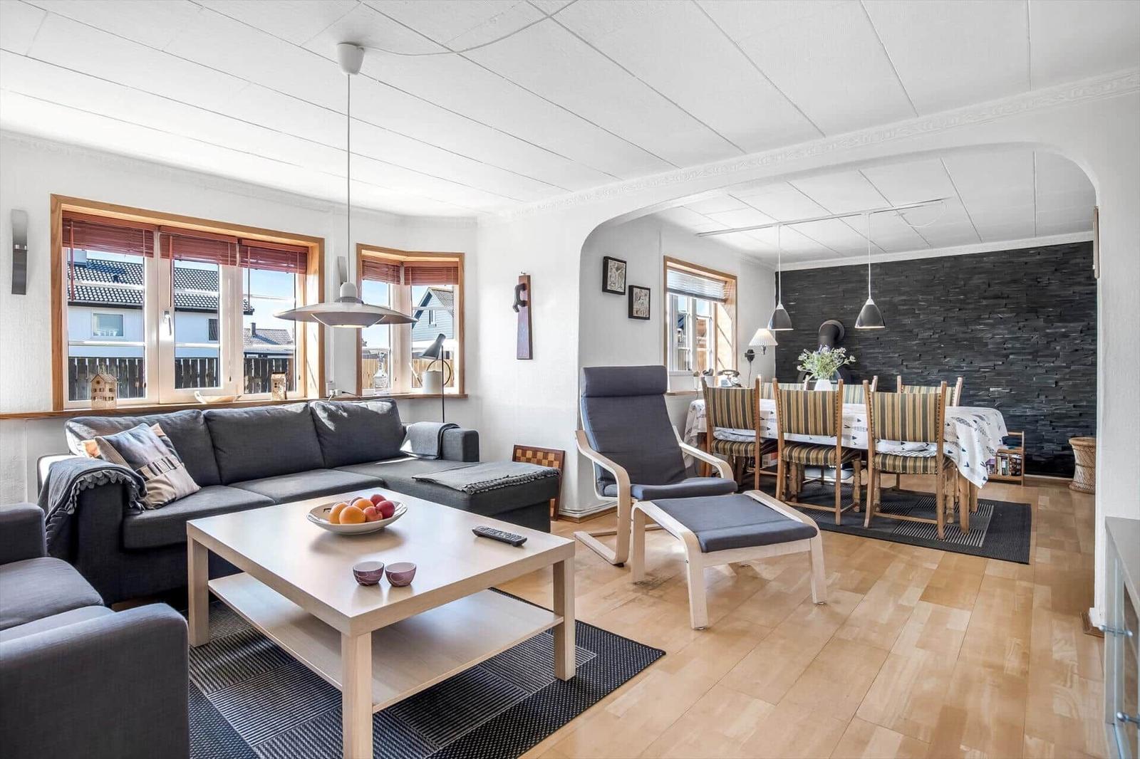 Living and dining area with sofa, dining table, and hardwood floor.