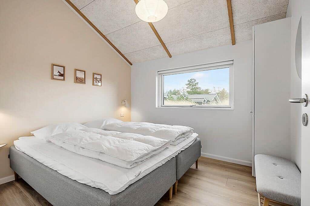 Bedroom with bed, window, and closet